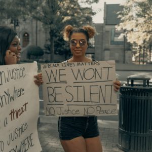 Two black women holding Black Lives Matter signs